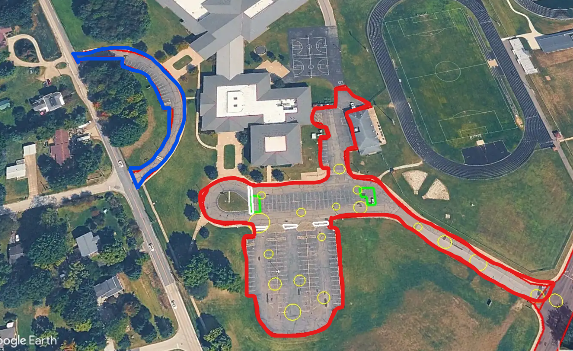 An arial photo of our middle school parking lot, highlighted in red, and our front loop, highlighted in blue